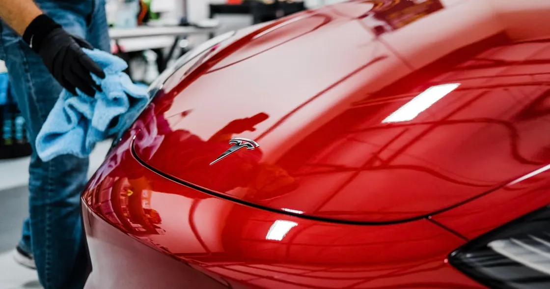 Detailer wiping down a freshly ceramic-coated car